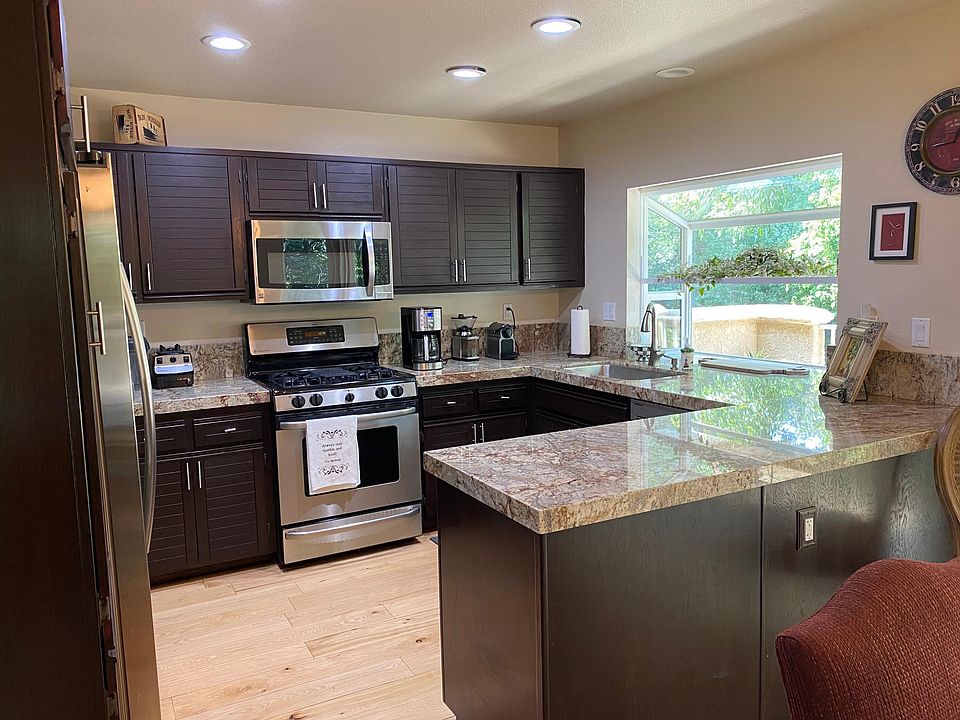 upgraded kitchen with gas range and double door refrigerator.