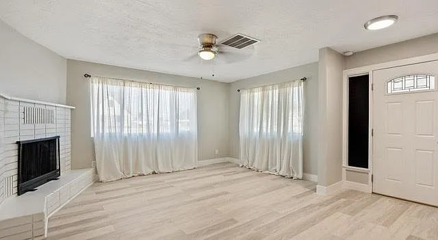 All draperies removed and custom blinds in place.