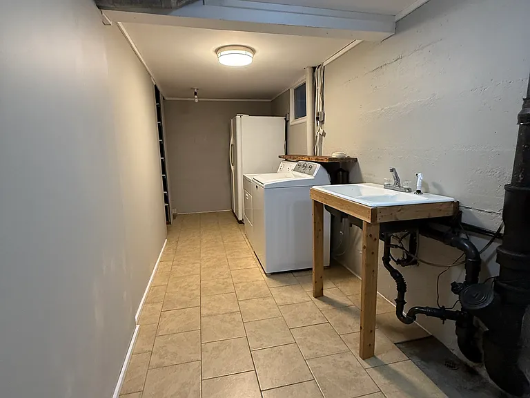 Basement laundry room. Washer and Dryer included along with an additional refrigerator/freezer. Large panty and sink