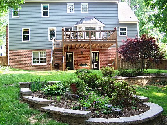 Multi-level stone walls, patio, & deck