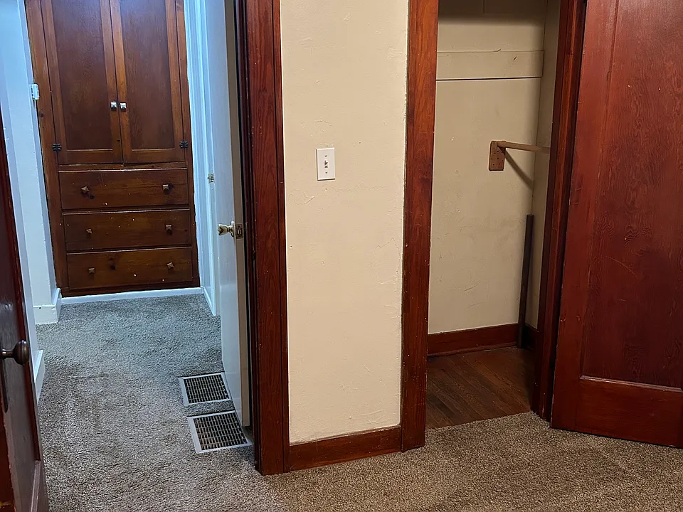 Bedroom closet, looking down hall to built in cabinet