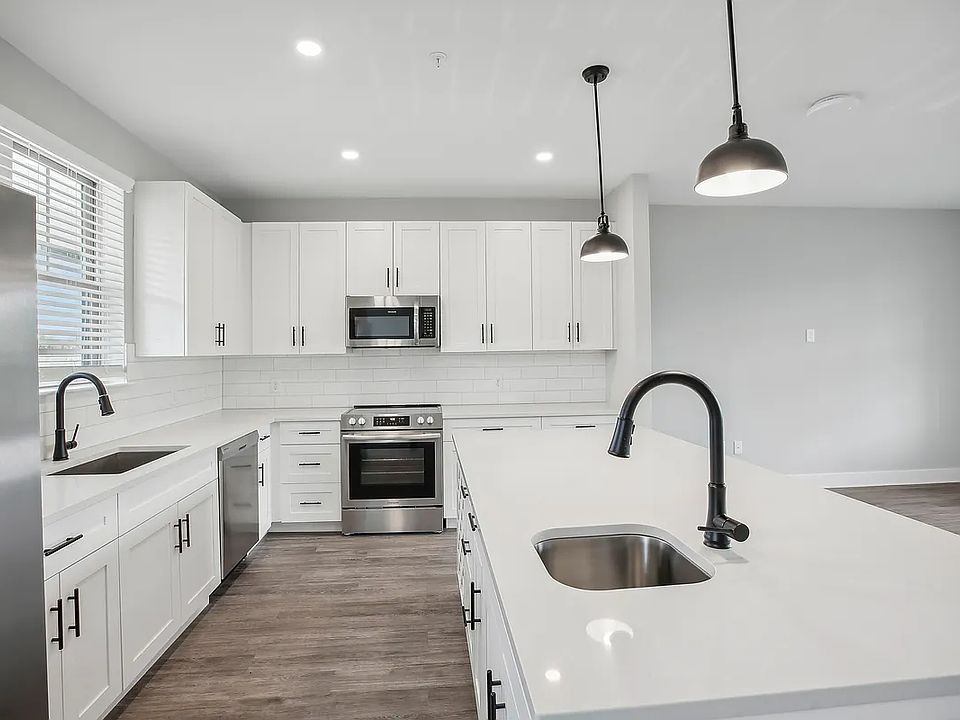 Open Kitchen layout with all new stainless steel appliances, designer lighting, quartz countertops, wine storage, etc.