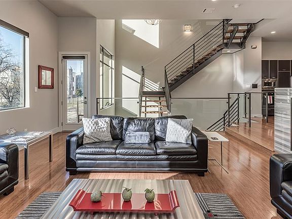 The spacious living area features 12' ceilings, automation controlled motorized shades, automation controlled lighting, fireplace and 5 zone home audio system. Natural light from all directions!