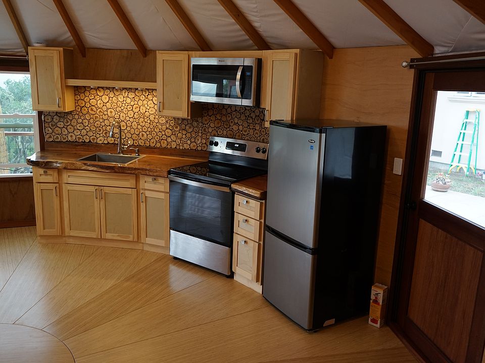 Another view of kitchen showing access door to secondary yurt bathroom