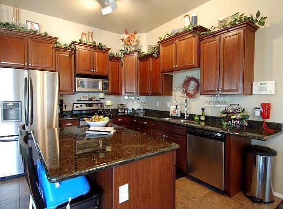beautiful staggered cherry cabinets, slab granite, stainless steel appliances