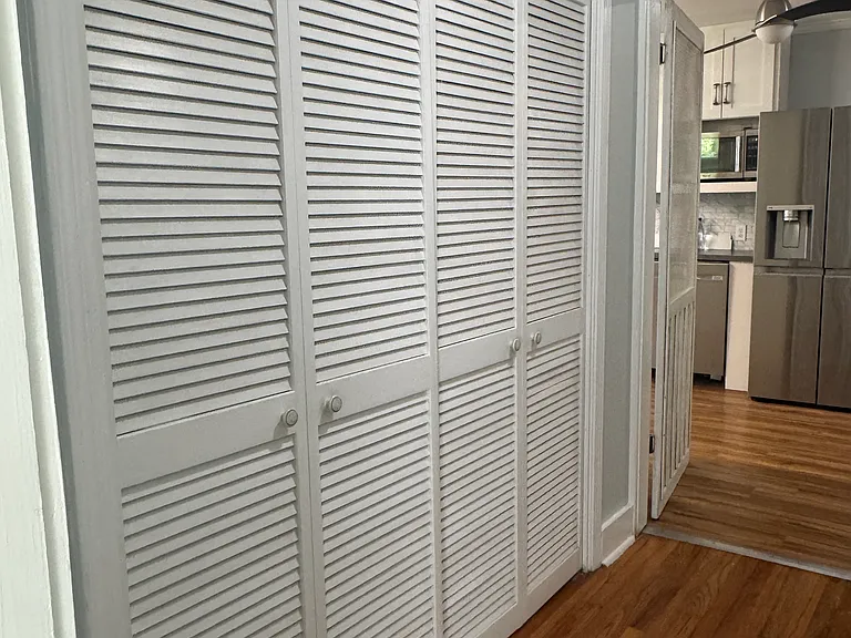 Hallway leading to laundry room - closed storage with built in closet system