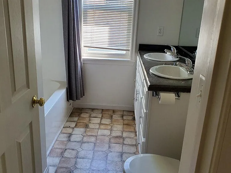 Upstairs bath with double vanity.
