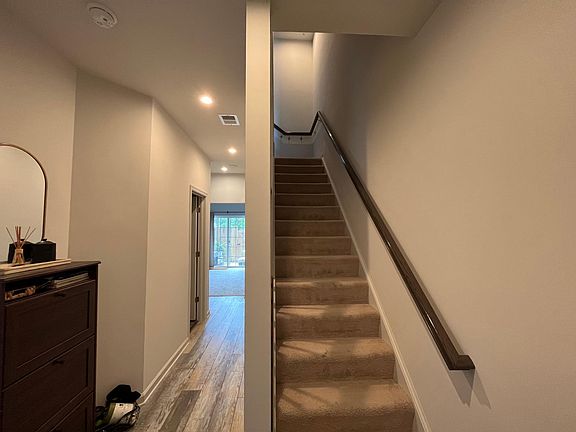 Hallway leading to rec room or potential fourth bedroom