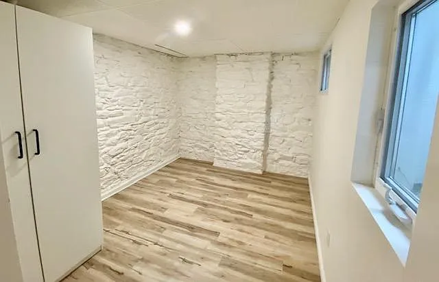 Bedroom sized to fit queen bed with two nightstands.