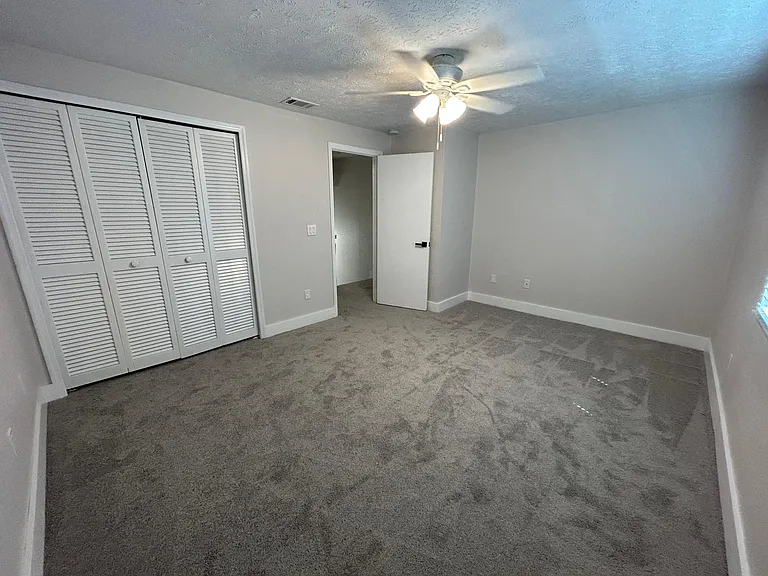 Bedroom #1 with large closet, brand new carpet, brand new fan, brand new blind and brand new energy efficient window.