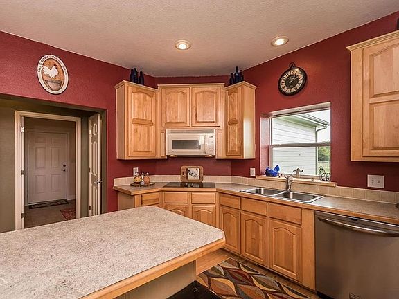 Kitchen is complete with lots of counter space and built in appliances. Hardwood flooring keeps space open and inviting.