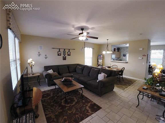 Living room/ Dining room combo with beautiful tile floor, ceiling fan and decora