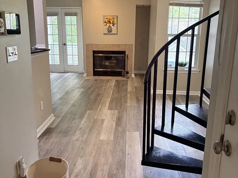Living Room view and spiral stairs that lead to loft