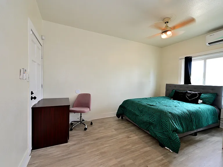 spacious and bright bedroom with furnishings + brand new ceiling fans and mini split AC