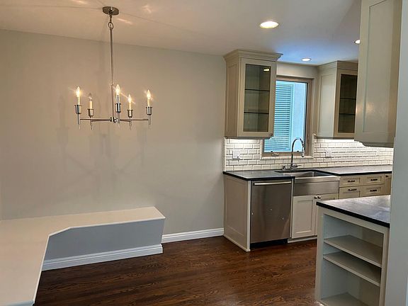 Kitchen with eat in dining table area with built in bench