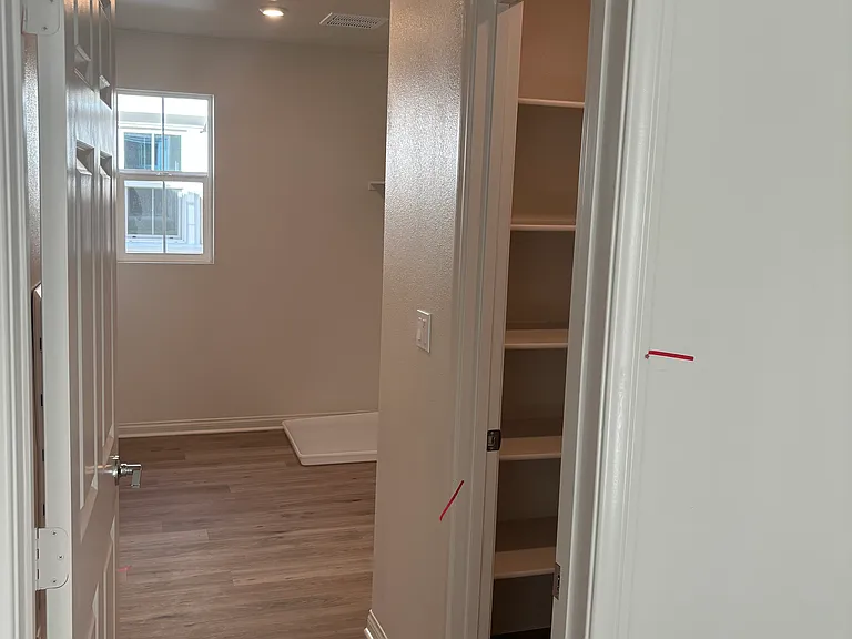 Laundry room with linen closet