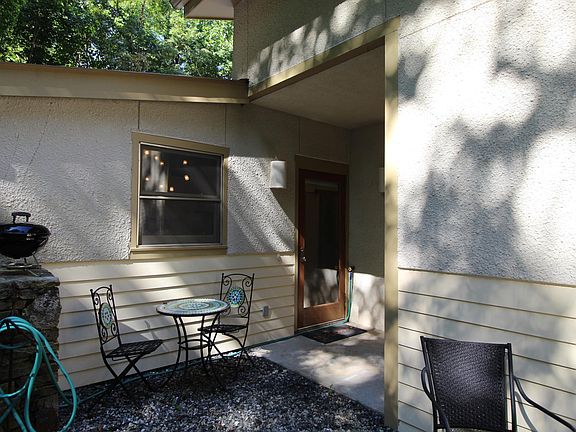 Front entry and sitting area featuring a portable grill and a chiminea (old-style outdoor fireplace, not shown in this picture).