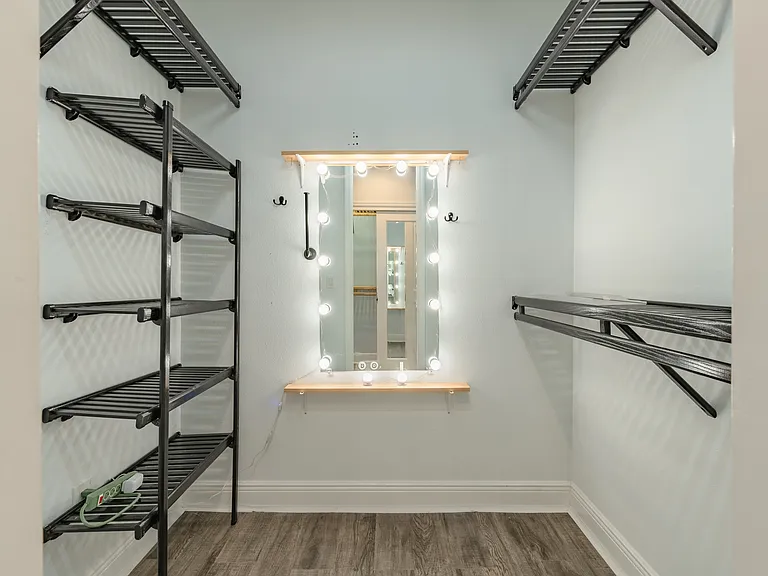 The primary closet is a walk-in closet with a built-in lighted makeup vanity.
