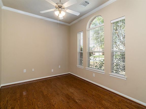 Behind the double French doors is this amazing flexible space! A study, workout room, additional bedroom, the choice is yours! Beautiful wood flooring, crown molding and windows with views of the trees!