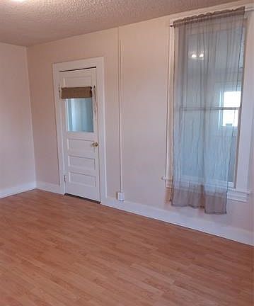 Original door from living room to front entry with original window to the right.