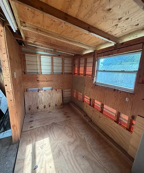 Side addition to the shed with room for storage shelves if desired.