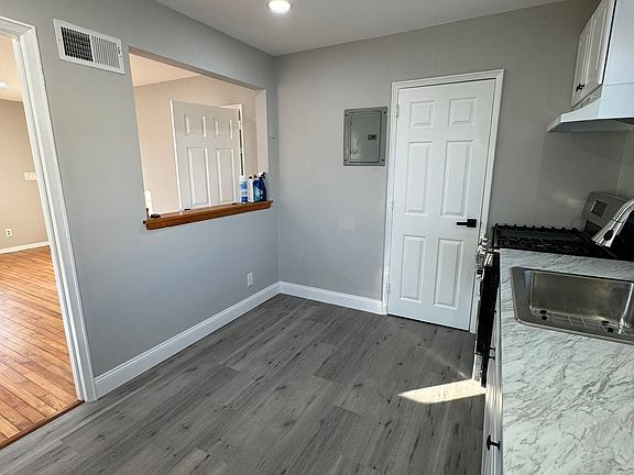 Kitchen view with entrance into half bathroom and In-Unit laundry.