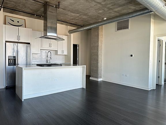 Chef's kitchen and stainless steel appliances, sun drenched in natural light