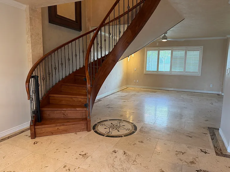 First Level - Large family room, curved stairway to second level.