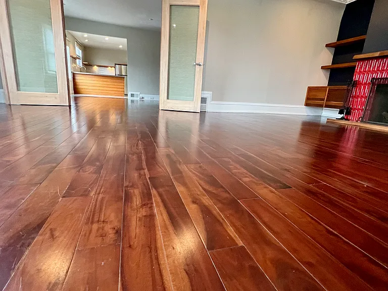 Separate living room with fireplace and doors towards entry living room dining room and kitchen
