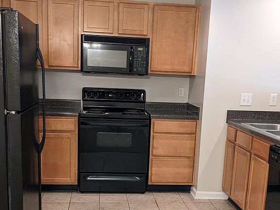 Kitchen with fridge, dishwasher, oven and microwave