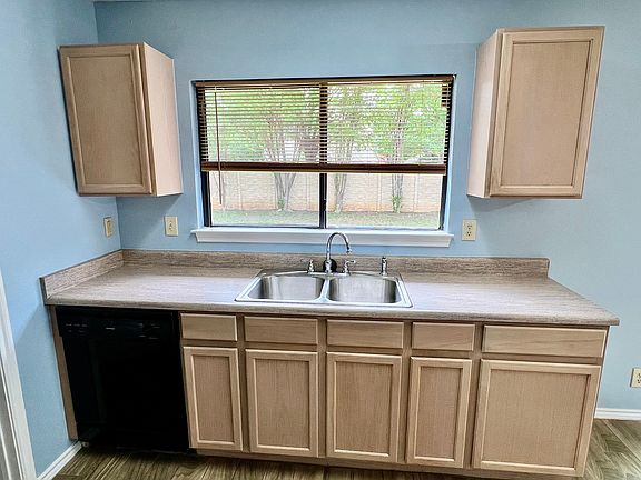 large windows with a beautiful view of the backyard