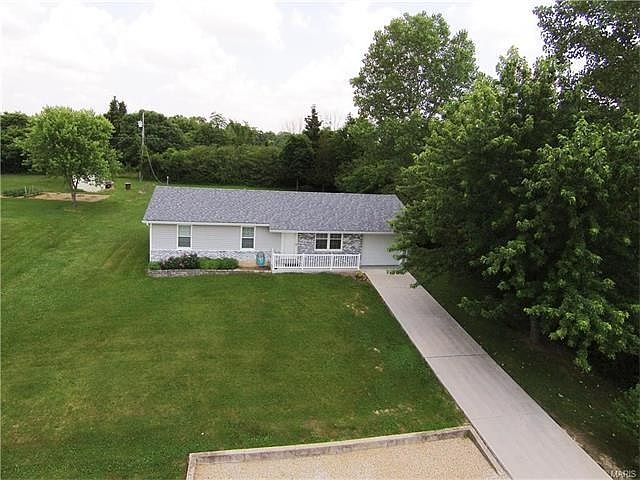 Newer Concrete Driveway to the garage with landscaped parking in front of home for extra guest.