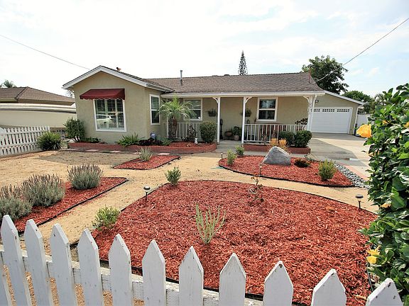 The front of the house features a covered patio, drought tolerant landscaping and picket fence all around. The driveway can comfortably fit 6 cars. RV or boat parking. Off street parking is also available. 