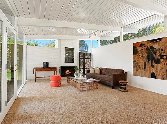 Living room with wood burning fireplace.