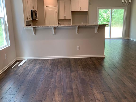 Great room looking toward the bar in the kitchen - hardwood floors in great room, kitchen, and hall