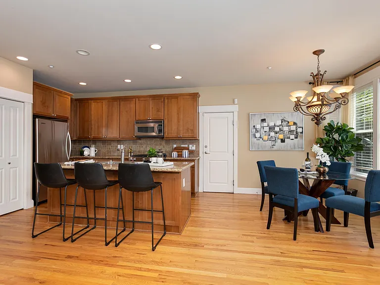 Kitchen and dining room spaces with hardwood flooring throughout.