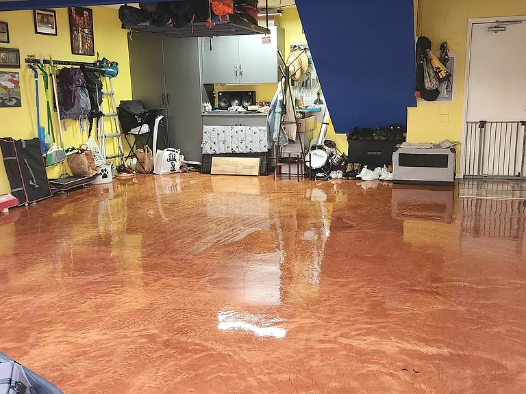 garage with big custom built closet and epoxy floor