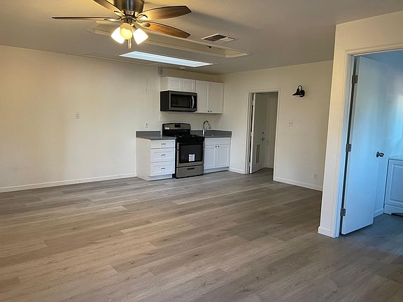 Large front room with kitchen and bathroom.