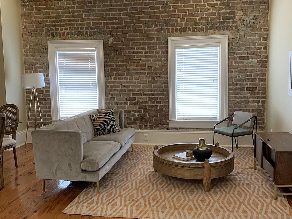 Open and spacious, tall ceilings, exposed brick, 2 windows and natural light in living area, updated