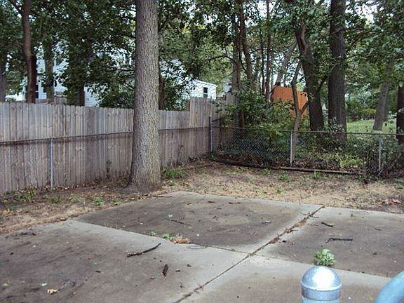 CEMENT PATIO WITH BASKETBALL HOOP