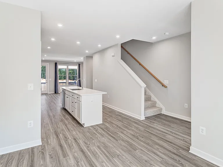 Comfortable carpeted staircase leading to the upper level bedrooms and laundry area.