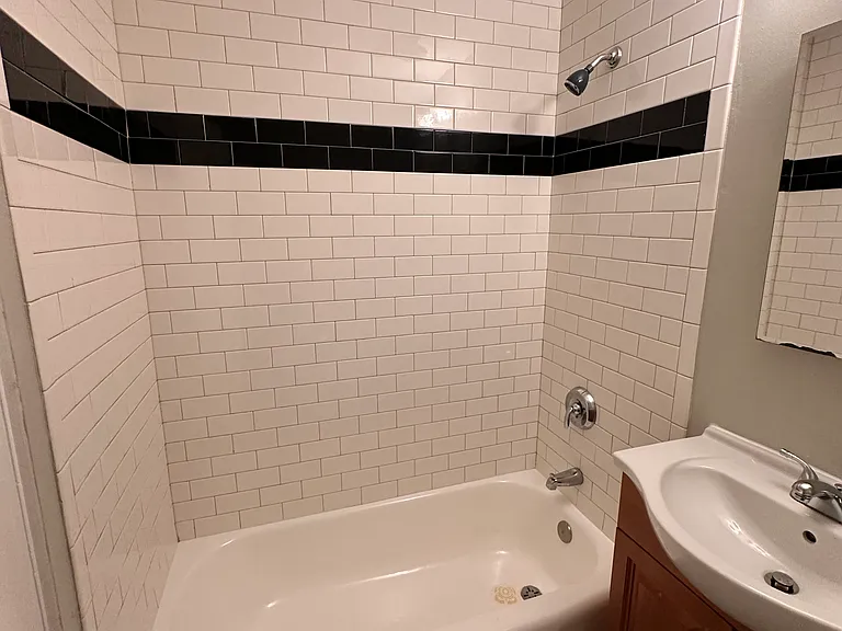 Bathroom with tiles floor and tiles tub surround