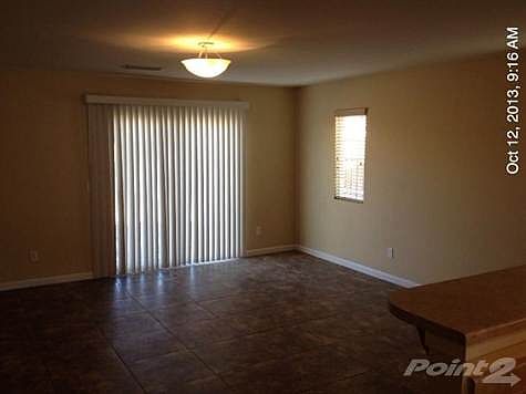 Family Room: Has an eating bar at kitchen and Custom Tile Floor. A slider opens to the back yard.