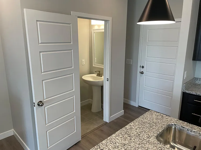 View of half bathroom and garage entry door (Floor 1)