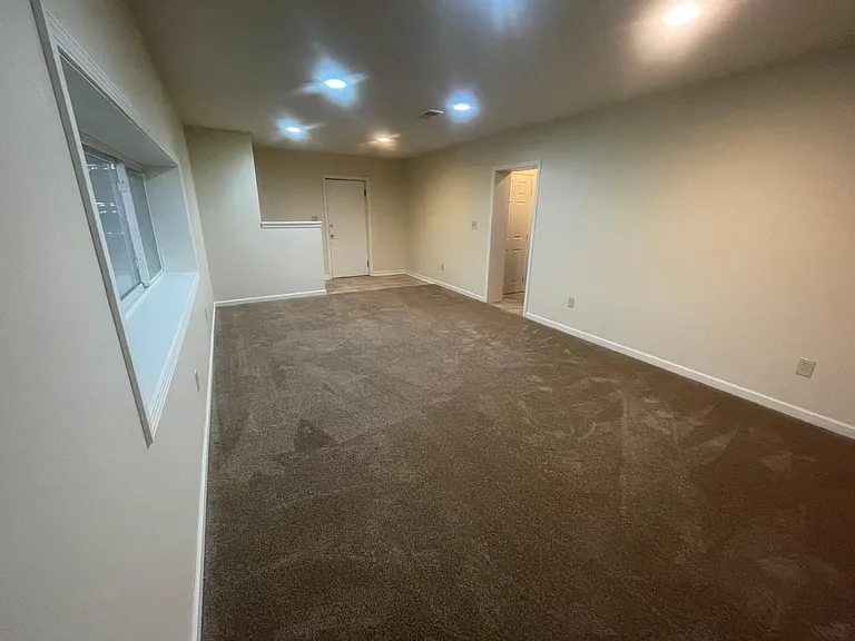 Lower level living room, garage access & walkout basement