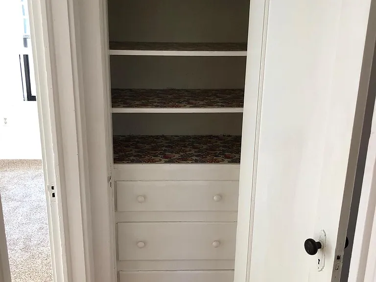 Linen closet with built in shelves and drawers