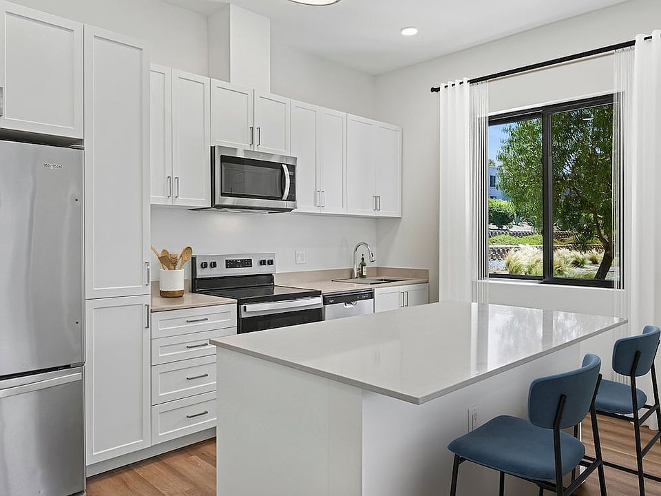 Coming Soon: Renovated Package II kitchen with stainless steel appliances, white cabinetry, beige quartz countertops, and hard-surface flooring