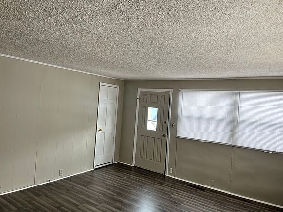 The front door opens up to a living room with new flooring, fresh paint and plenty of windows to let in natural light.