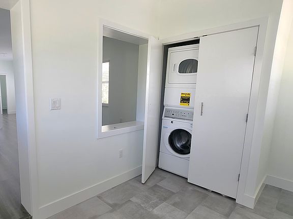 Efficient in-house washer and dryer in hideaway closet.