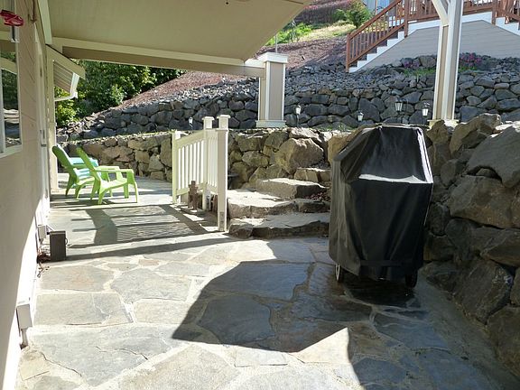 Large covered rock deck patio. Great place to cool off in the summer & barbecue year round.